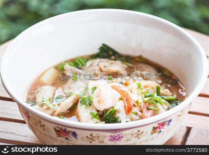 Thai spicy noodles soup with pork and seafood