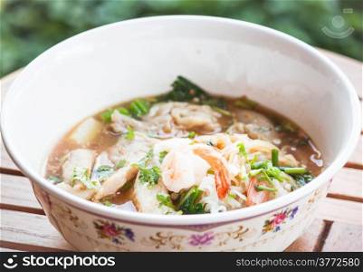 Thai spicy noodles soup with pork and seafood