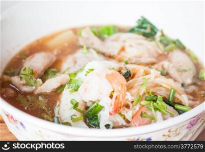 Thai spicy noodles soup with pork and shrimp
