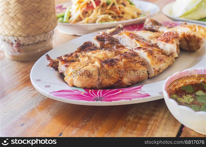 Thai style spicy meal, chicken grilled with spicy papaya salad and sticky rice box