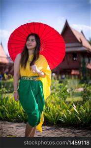 Thai woman dressing with umbrella traditional style