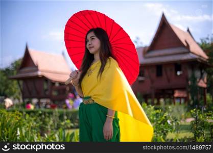 Thai woman dressing with umbrella traditional style
