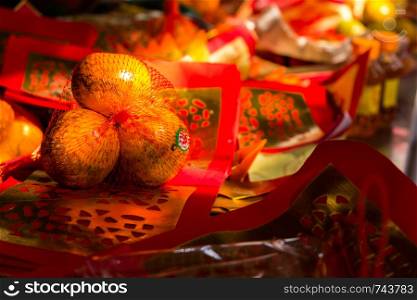 Thailand Bangkok - January 29 2018 : Three Tangerines with silver and gold papers is component in worshiping Chinese god,Chinese new year,Wat Lengnoeiyi,Yaowarat