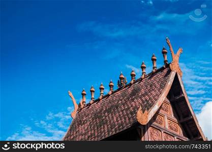 Thailand northern antique roof with blue sky background.