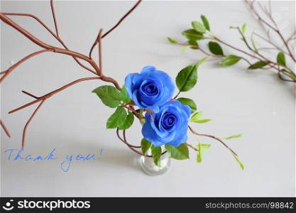 Thank you background with grateful message, two blue roses with green leaf from clay art on white background, card for teacher day, mother day or woman day