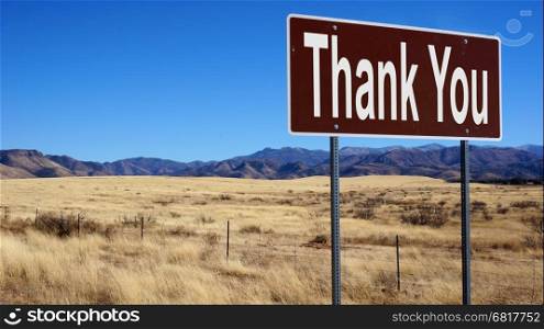 Thank You brown road sign with blue sky and wilderness