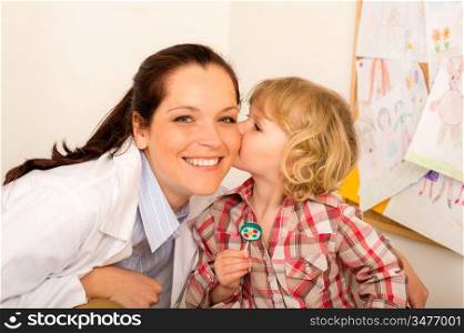 Thank you doctor - Little girl kissing female pediatrician