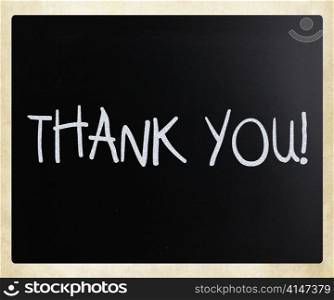""Thank you" handwritten with white chalk on a blackboard"