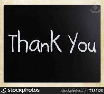 ""Thank you" handwritten with white chalk on a blackboard"