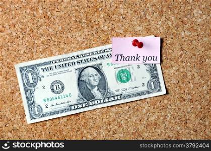 thank you memo note and dollar bill affixed to the corkboard