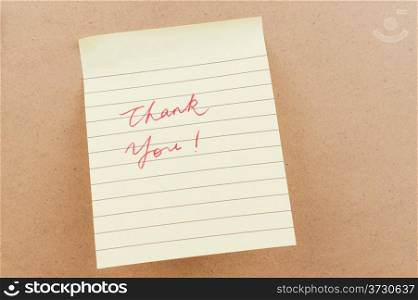 Thank you words written on a sticky note
