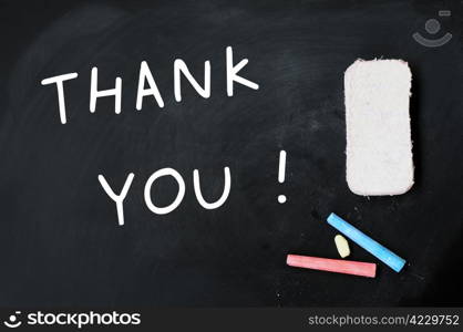 Thank you written on a blackboard, with eraser and chalk