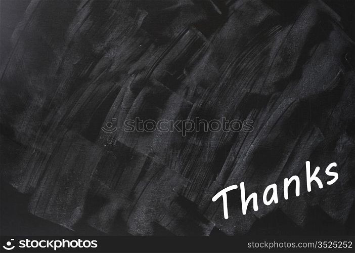 Thanks written on a smudged blackboard background with copy space for text and design