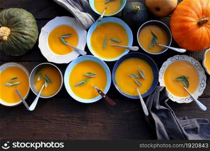 Thanksgiving concept with pumpkin, pumpkin soup .Fall table setting for celebration Autumn holiday with soup.