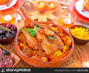 Thanksgiving day dinner, traditional festive food, tasty oven baked turkey with vegetables and lemon, beautiful decorated holiday table