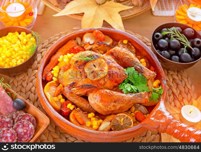 Thanksgiving day dinner, traditional festive food, tasty oven baked turkey with vegetables and lemon, beautiful decorated holiday table