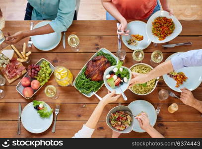 thanksgiving day, eating and leisure concept - group of people having dinner at table with food. group of people eating at table with food