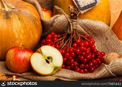 Thanksgiving Day pumpkin and apple. pumpkin and red apple on Thanksgiving Day on the wooden background