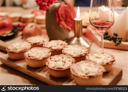 Thanksgiving Fall traditional homemade apple pies on wooden board for autumn holiday dining. Cozy home mood