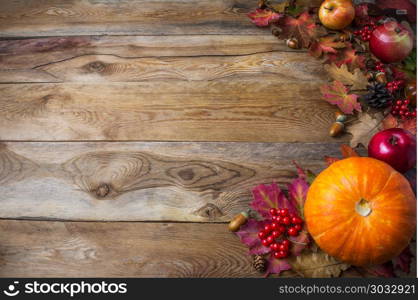 Thanksgiving or fall greeting background with pumpkins and fall leaves. Thanksgiving background with seasonal vegetables and fruits. Fall background. Copy space. Thanksgiving or fall greeting background with pumpkins and fall