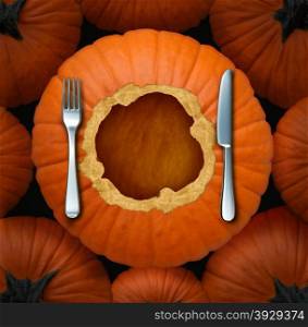 Thanksgiving seasonal food celebration concept as an autumn cuisine symbol with an orange pumpkin cut as a circular dinner plate with a fork and knife table setting for gourmet fall food menu with a blank area as copy space.