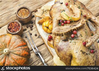 Thanksgiving whole duck on rustic wooden background. Festive baked duck