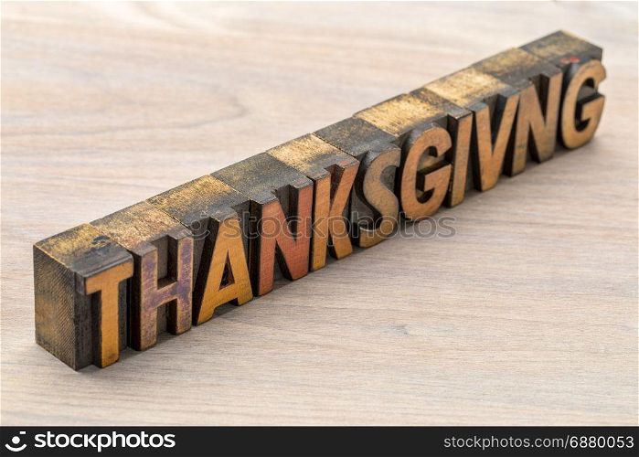 Thanksgiving word abstract in vintage letterpress wood type against grained wood