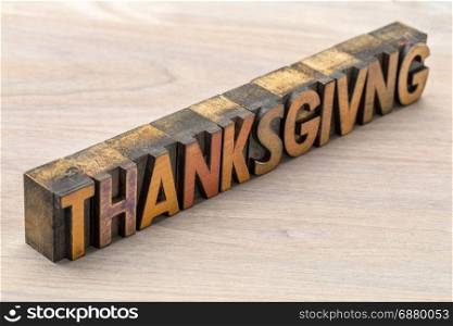 Thanksgiving word abstract in vintage letterpress wood type against grained wood