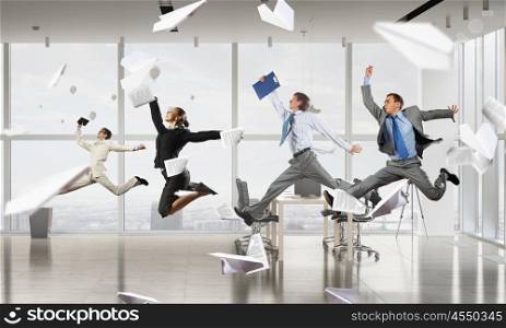 That feeling of freedom. Happy young businesspeople running away from office