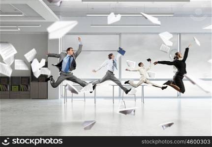 That feeling of freedom. Happy young businesspeople running away from office