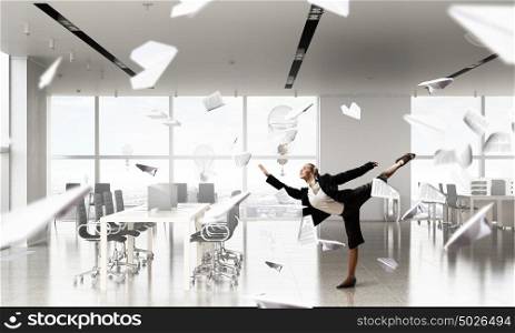 That feeling of freedom. Happy young businesswoman dancing in modern office
