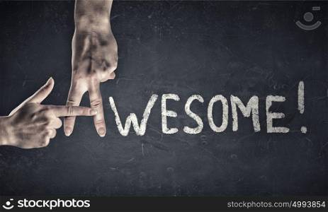 That is awesome. Awesome word written on wall and fingers instead letter A