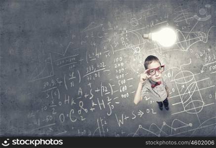 That is interesting point. Top view of cute schoolboy in red glasses on chalkboard background