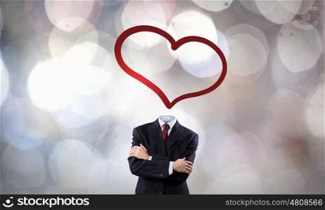 That love feeling. Faceless businessman with heart instead of head