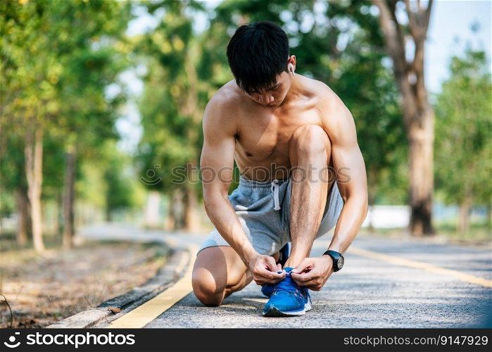 That man laced a shoelace to exercise. Selective focus.