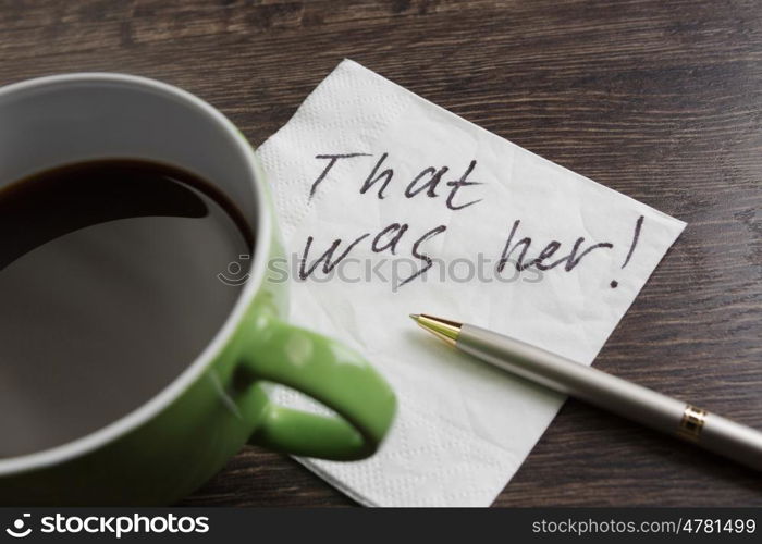 That was her. Message written on napkin and coffee cup on wooden napkin