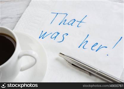 That was her. Message written on napkin and coffee cup on wooden napkin