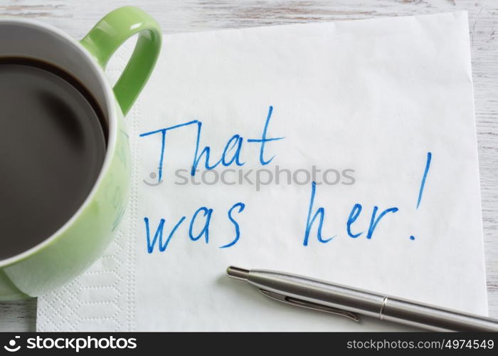 That was her. Message written on napkin and coffee cup on wooden napkin