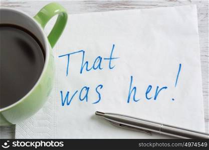 That was her. Message written on napkin and coffee cup on wooden napkin