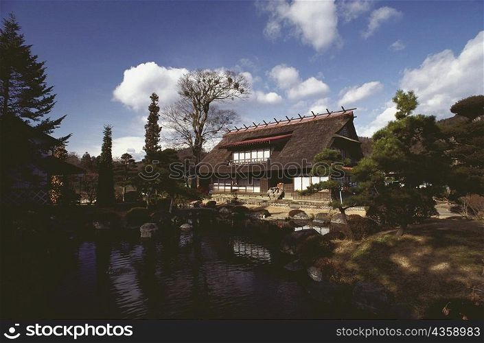 Thatched farm house in front of a lake, Hakone, Kanagawa Prefecture, Japan