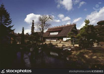 Thatched farm house in front of a lake, Hakone, Kanagawa Prefecture, Japan