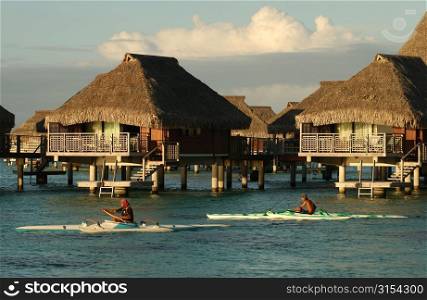 Thatched roof wooden structures built on stilts in the sea, Moorea, Tahiti, French Polynesia, South Pacific