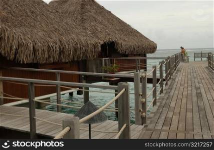 Thatched roof wooden structures supported by stilts in the sea, Moorea, Tahiti, French Polynesia, South Pacific