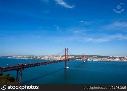 The 25 de Abril Bridge in Lisbon Portugal over Tagus river at clear sunny summer day