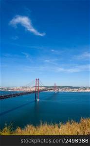 The 25 de Abril Bridge in Lisbon Portugal over Tagus river at clear sunny summer day