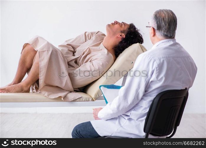 The aged male doctor psychiatrist examining young patient . Aged male doctor psychiatrist examining young patient 