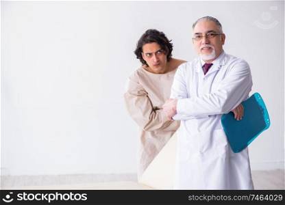 The aged male doctor psychiatrist examining young patient . Aged male doctor psychiatrist examining young patient 