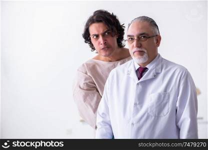 The aged male doctor psychiatrist examining young patient . Aged male doctor psychiatrist examining young patient