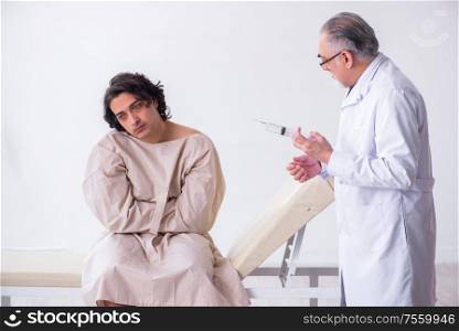 The aged male doctor psychiatrist examining young patient. Aged male doctor psychiatrist examining young patient
