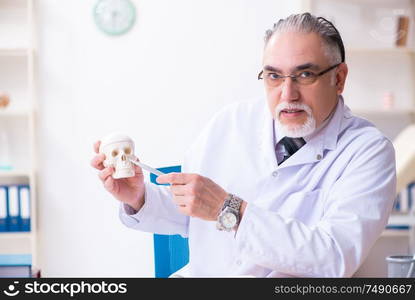 The aged male doctor with skeleton. Aged male doctor with skeleton